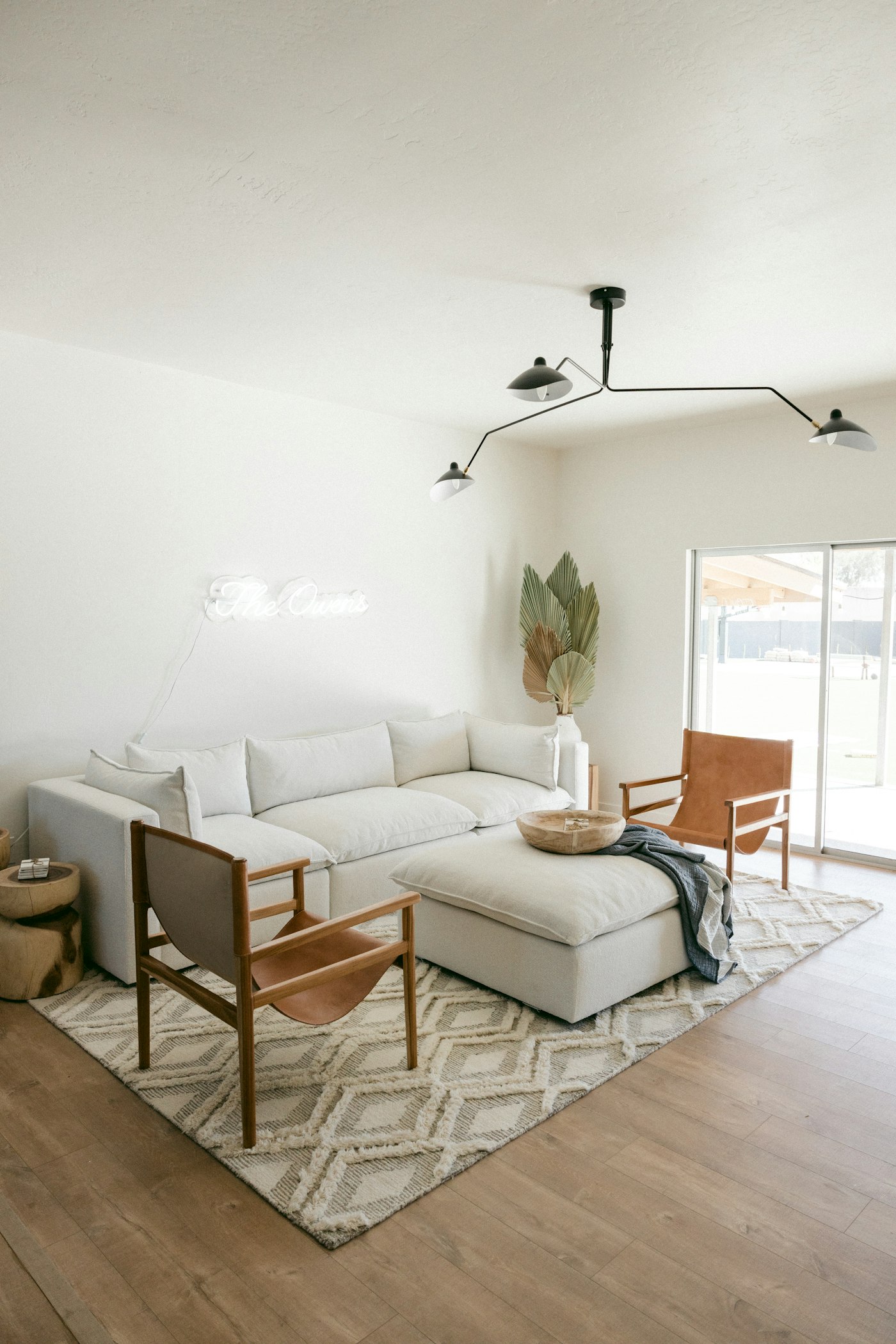 Neutral living room with an oversized rug and warm wood floors